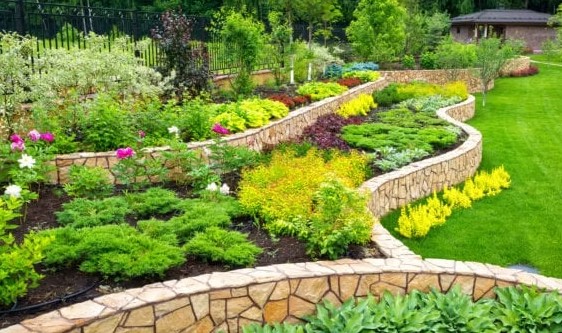 Multi-tier stone retaining wall and plantings